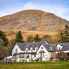 Exterior view of Glen Clova Hotel with glens in the background