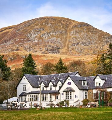 Exterior view of Glen Clova Hotel with glens in the background