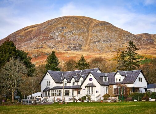 Exterior view of Glen Clova Hotel with glens in the background
